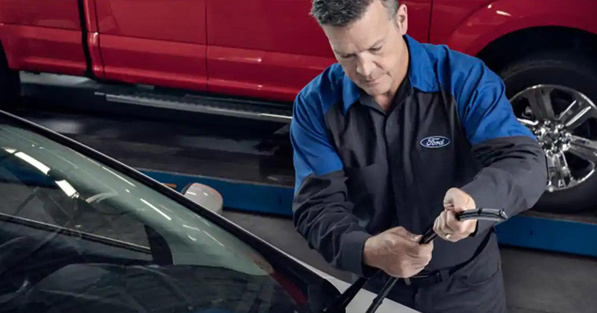 Ford service technician replacing a windshield wiper.