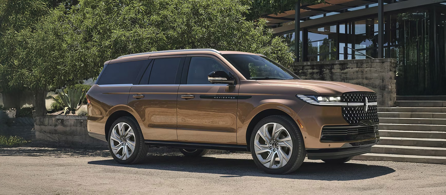 2025 Lincoln Navigator SUV parked outside a modern home, luxury full-size SUV available at South Bay Ford near Los Angeles, CA.