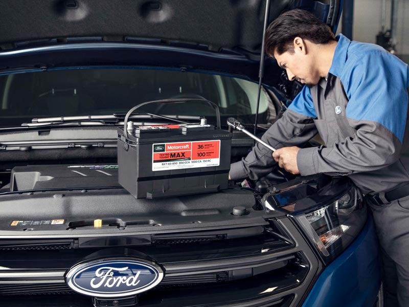 Mechanic installing Ford Battery